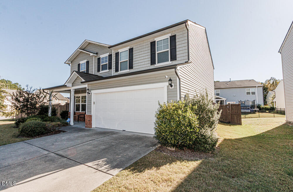 3425 Teravista Way Raleigh, NC 27616 - Photo 3 of 49 a front view of a house with a yard