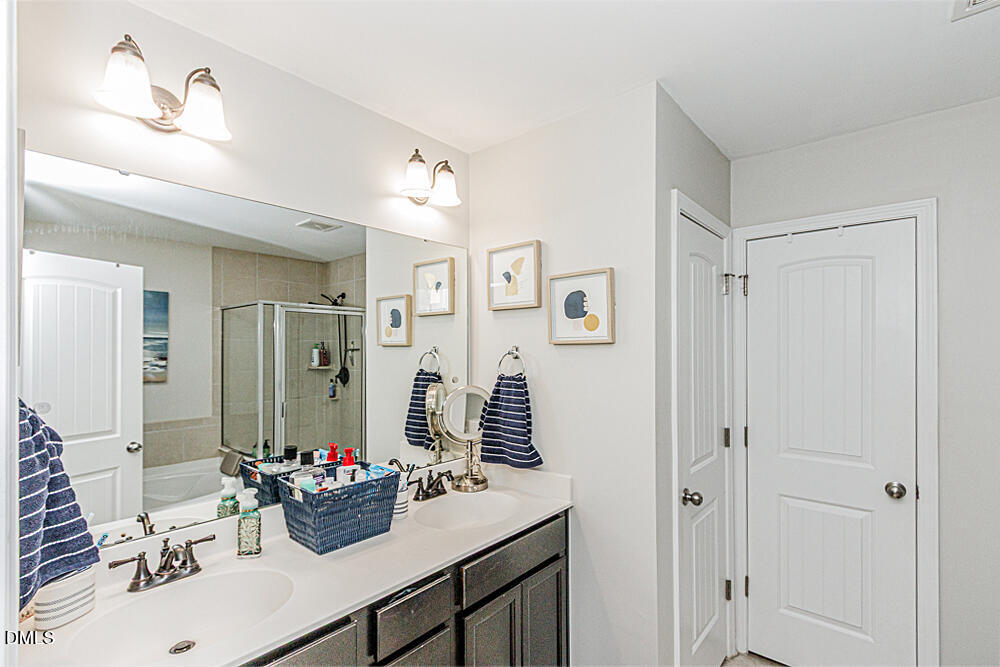 3425 Teravista Way Raleigh, NC 27616 - Photo 31 of 49 a bathroom with a sink double vanity and a mirror