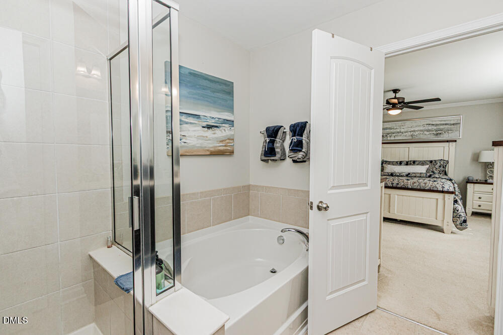 3425 Teravista Way Raleigh, NC 27616 - Photo 32 of 49 a bathroom with a bathtub and a shower