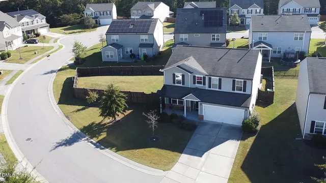 a front view of a house with a yard and outdoor seating