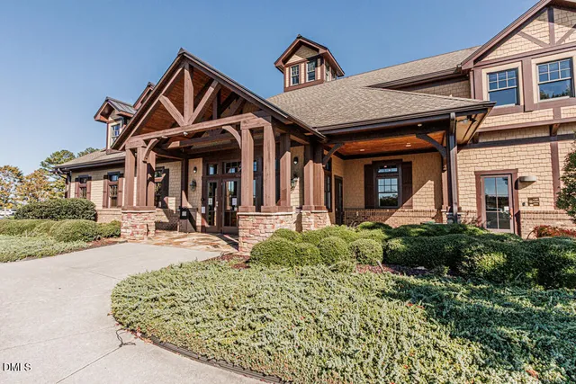 a living room with furniture a fireplace and a large window