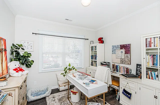 a living room with furniture and book shelf