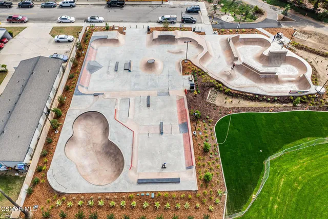 an aerial view of a swimming pool with a yard