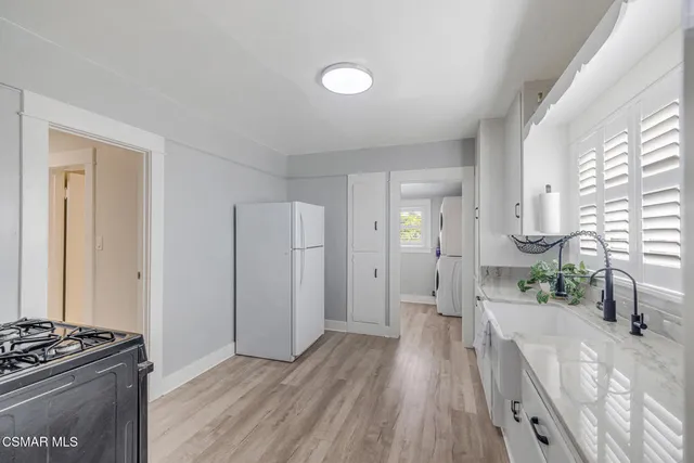 a view of a kitchen counter space and wooden floor