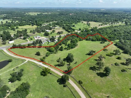 an aerial view of a golf course with parking space