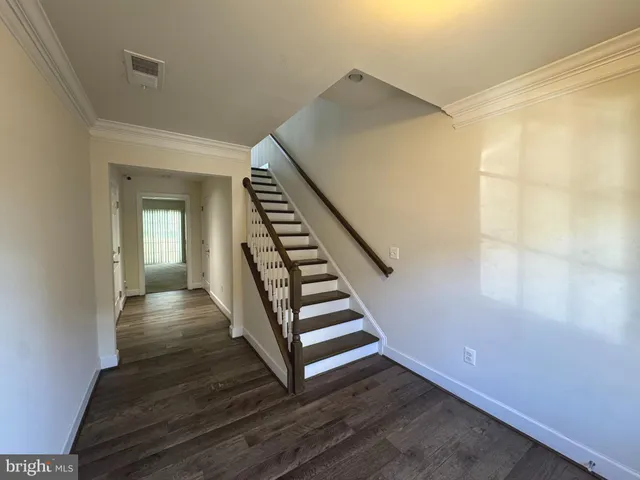 a view of an entryway with wooden floor