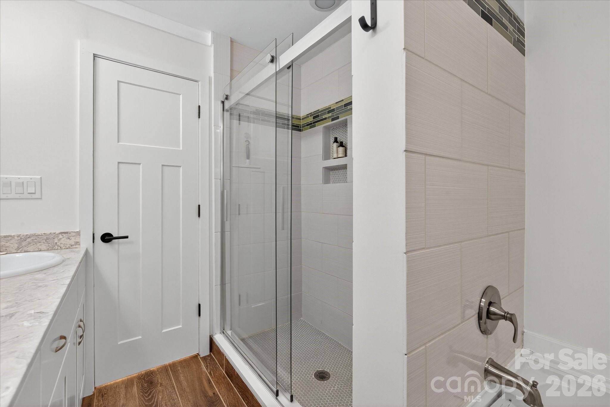 6431 Rosecrest Drive Charlotte, NC 28210 - Photo 13 of 46 a bathroom with a granite countertop shower sink and vanity