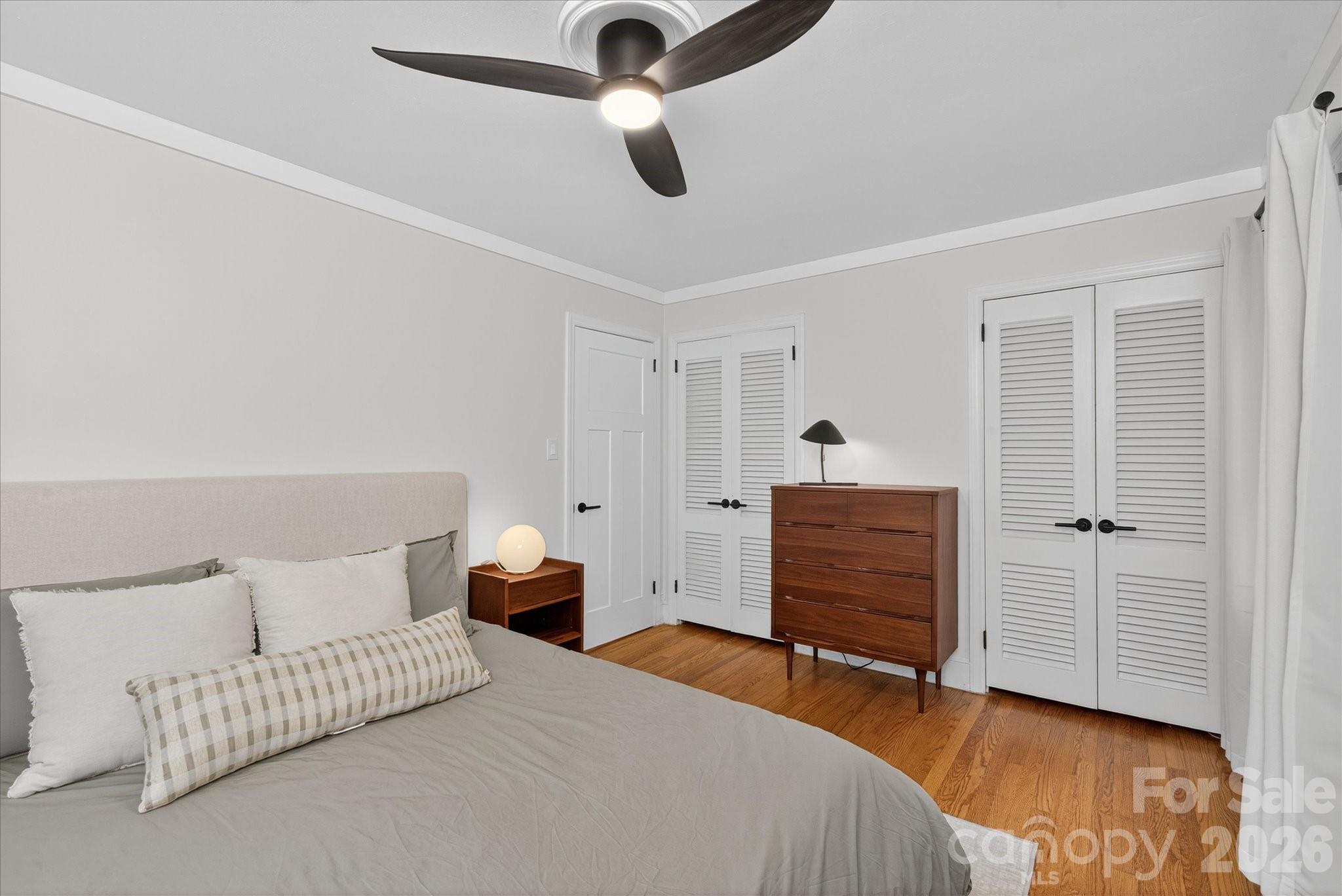 6431 Rosecrest Drive Charlotte, NC 28210 - Photo 15 of 46 a bedroom with a bed and cabinets