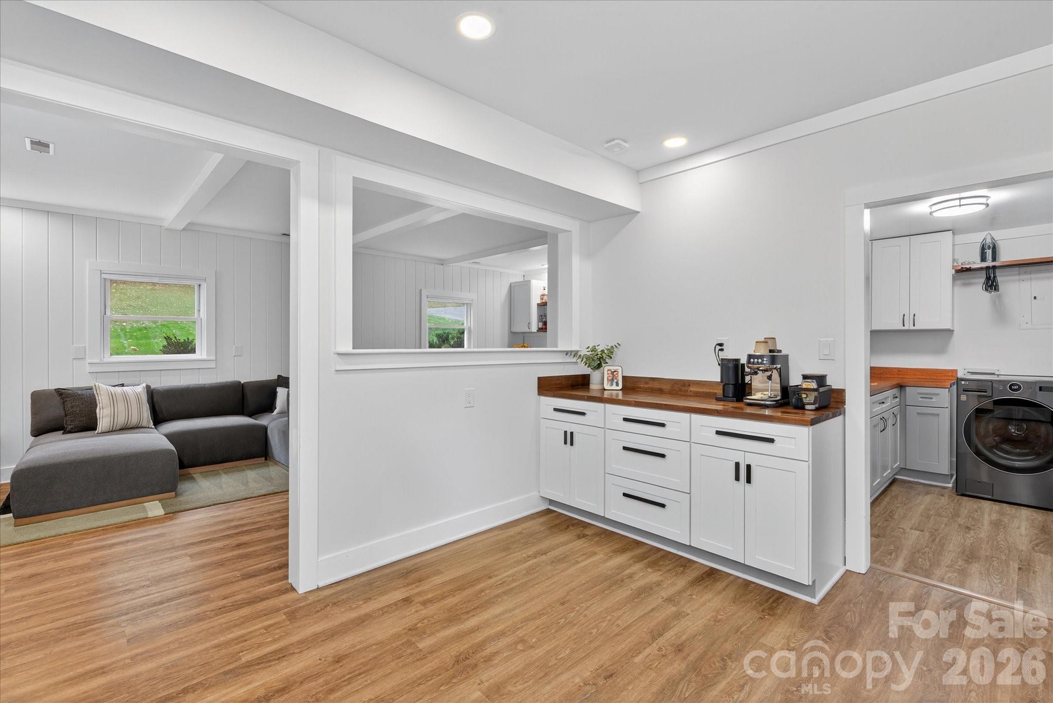 6431 Rosecrest Drive Charlotte, NC 28210 - Photo 31 of 46 a kitchen with a white cabinets and wooden floor