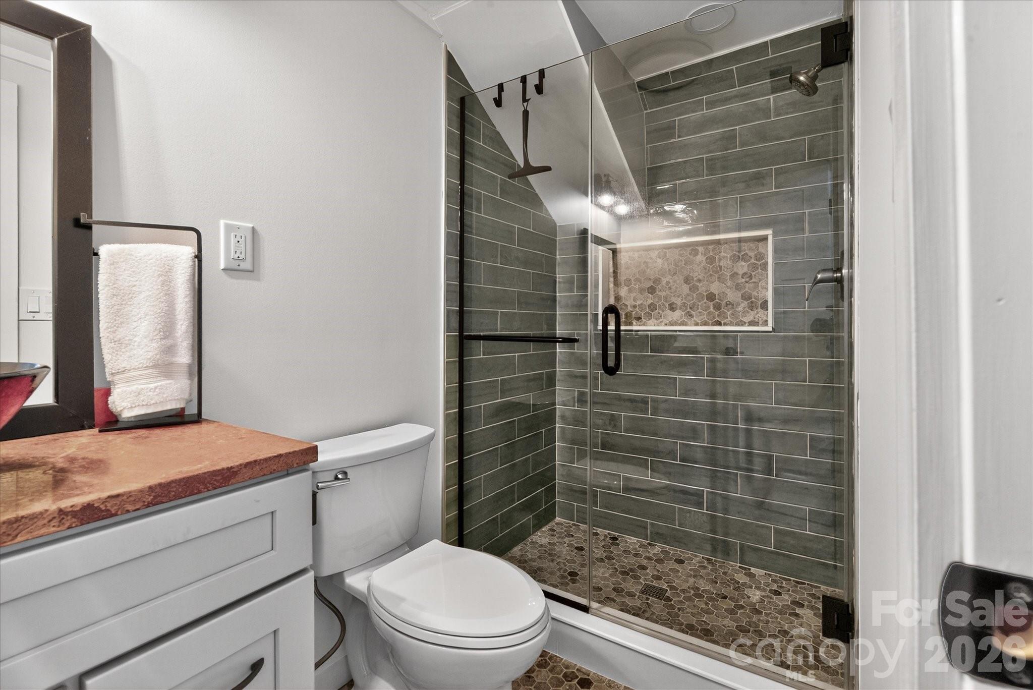 6431 Rosecrest Drive Charlotte, NC 28210 - Photo 34 of 46 a bathroom with a toilet and shower