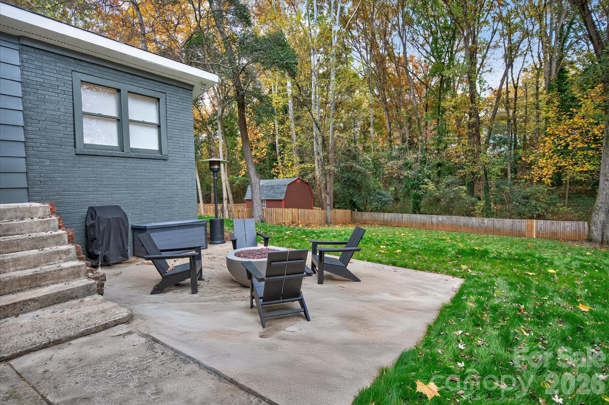 6431 Rosecrest Drive Charlotte, NC 28210 - Photo 40 of 46 a view of a patio with table and chairs potted plants and a large tree