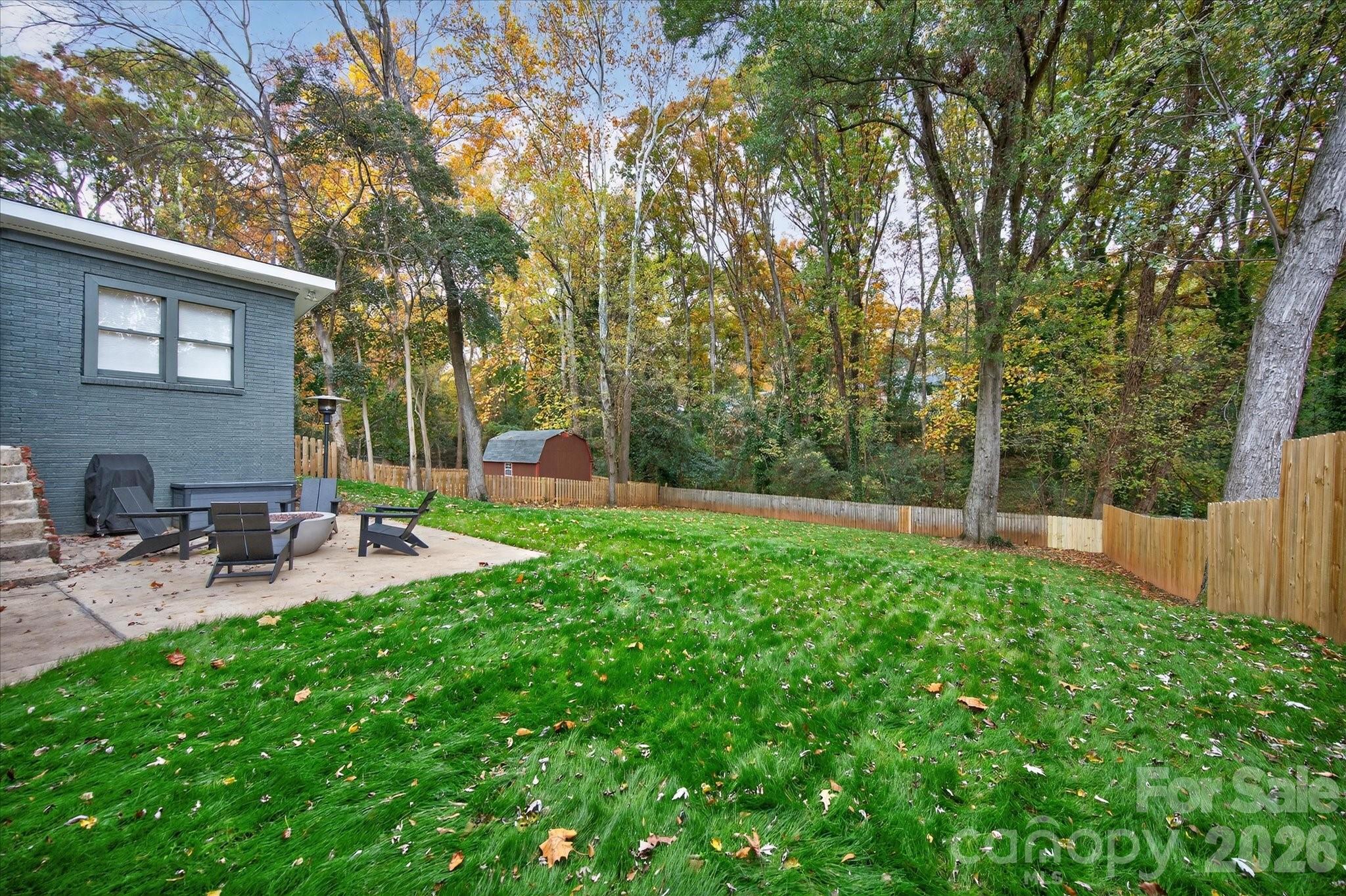 6431 Rosecrest Drive Charlotte, NC 28210 - Photo 43 of 46 a view of backyard with a table and chairs and wooden fence