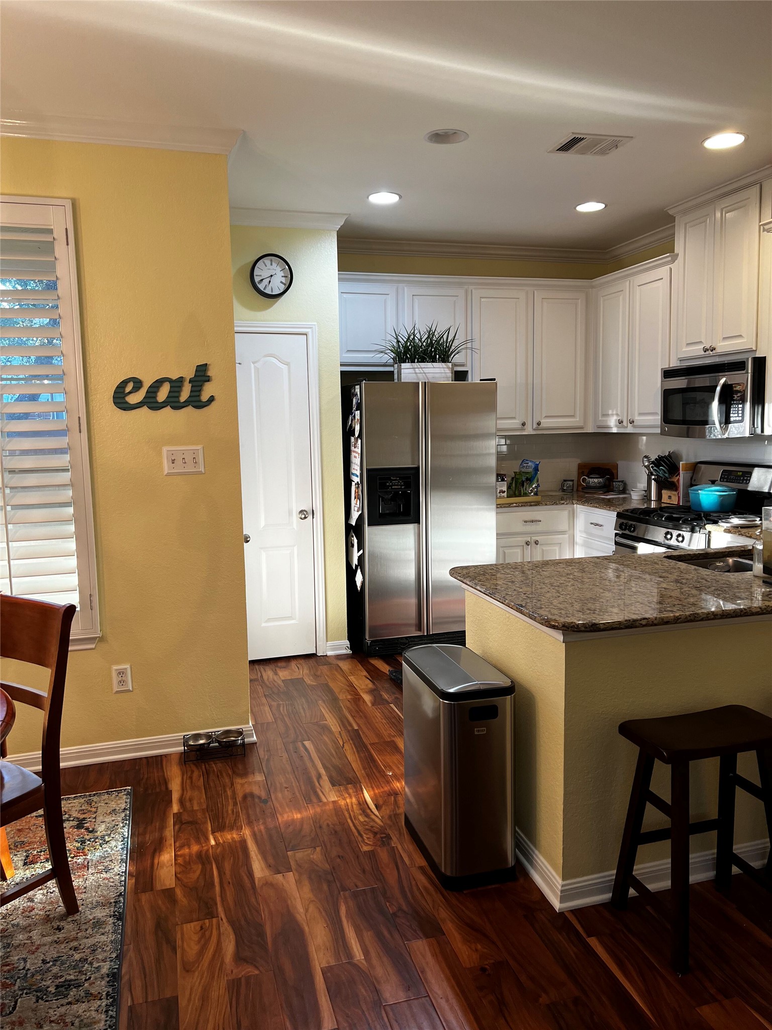 11000 Anderson Mill Road, Unit 93 Austin, TX 78750 - Photo 5 of 27 Culinary creativity comes alive in this kitchen, featuring stainless steel appliances and rich wood flooring.
