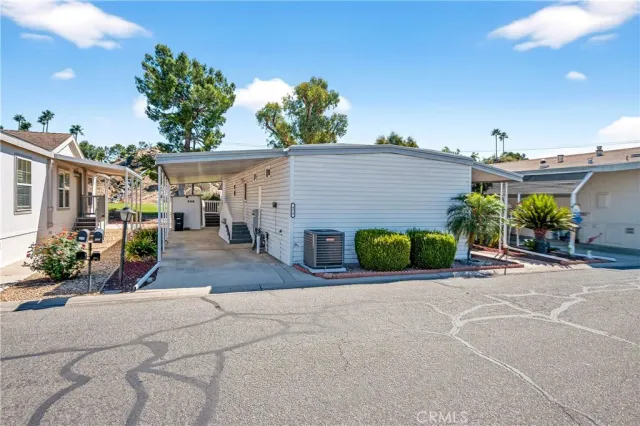 a view of a house with garage and a chairs