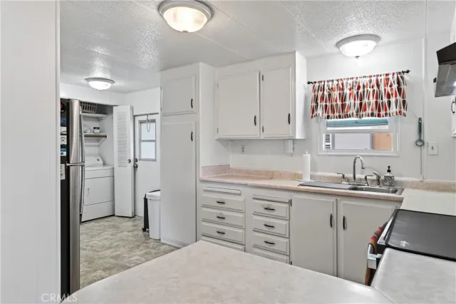 a kitchen with cabinets appliances and a sink