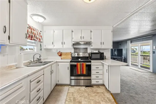 a kitchen with stainless steel appliances granite countertop a sink and cabinets
