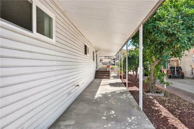 a view of a balcony with wooden floor and fence