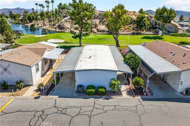 an aerial view of a city with lots of residential buildings ocean and mountain view in back