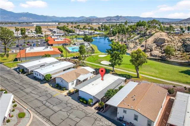 an aerial view of residential houses with outdoor space and river