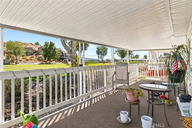a view of a balcony with chairs and a table