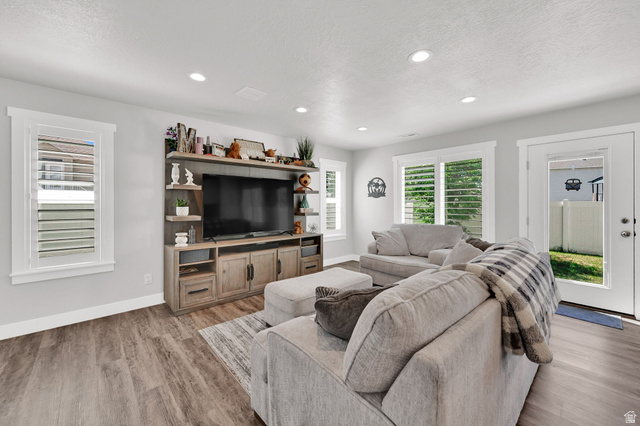 2777 West 4175th Street South, Unit 232 Roy, UT 84067 - Photo 5 of 27 Open-concept living space/kitchen featuring LVP flooring, recessed lighting, and white plantation shutters