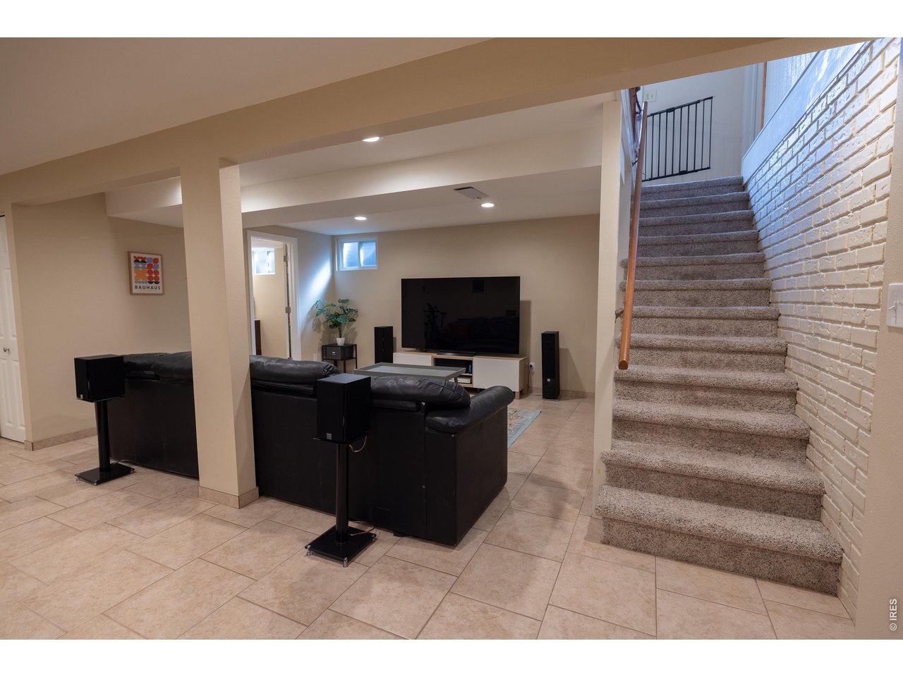 3320 23rd Street Boulder, CO 80304 - Photo 14 of 25 Spacious lower-level rec room-perfect for movie nights, games, and gathering with family and friends.