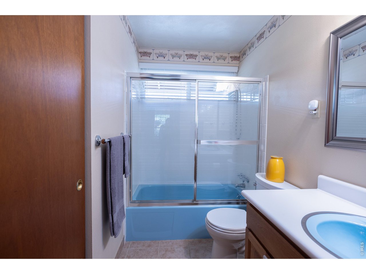 3320 23rd Street Boulder, CO 80304 - Photo 19 of 25 Full main-level bathroom featuring an exceptionally large storage closet and a window for natural light and ventilation.