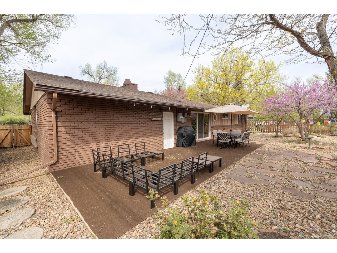 3320 23rd Street Boulder, CO 80304 - Photo 9 of 25 Efficient xeriscaped backyard designed for durability and minimal maintenance, with flexible space for outdoor use.