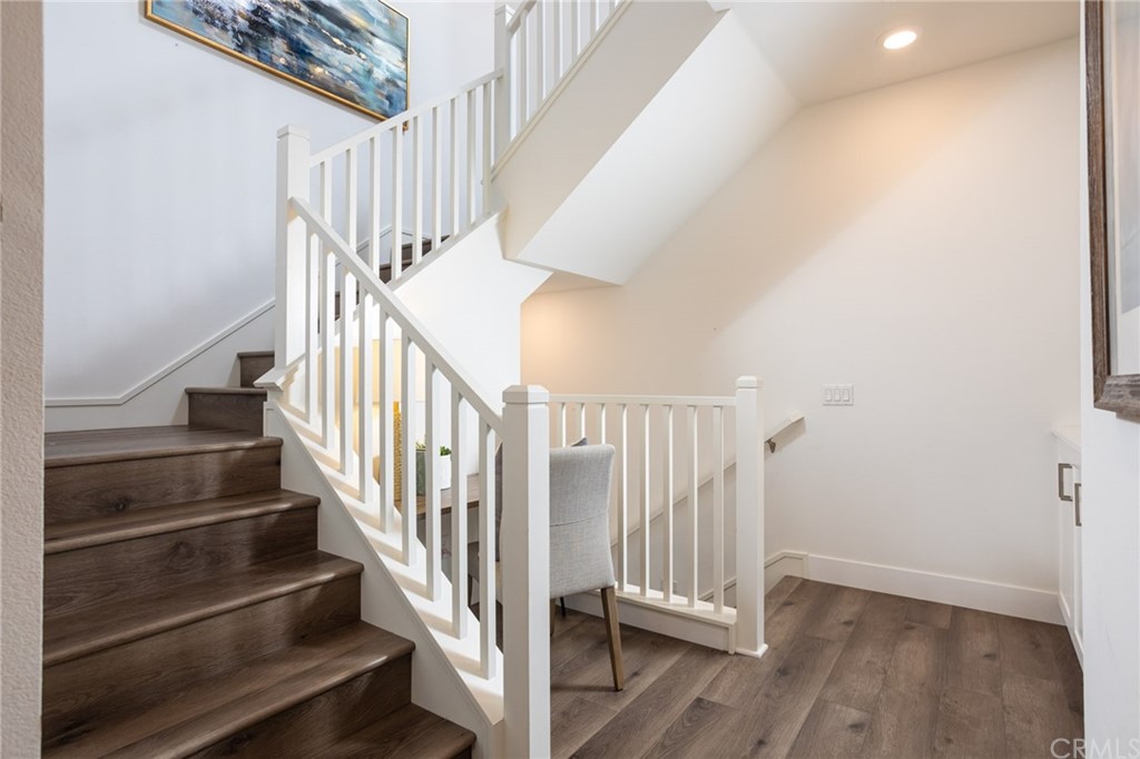 82 Ballast Point Tustin, CA 92782 - Photo 15 of 30 a view of staircase with wooden floor and white walls