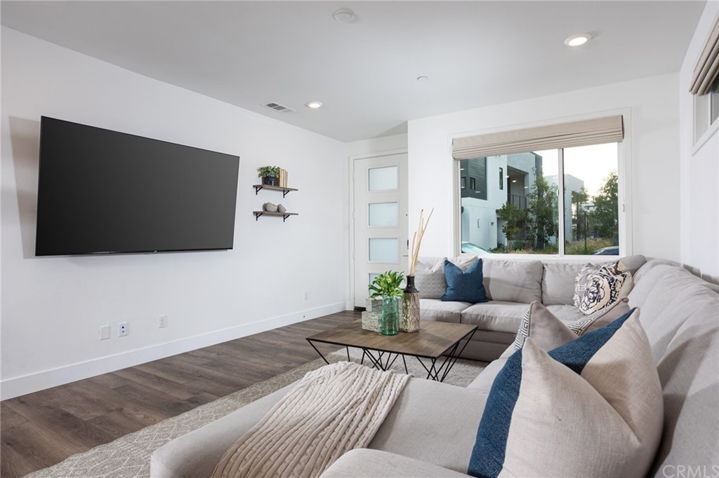 82 Ballast Point Tustin, CA 92782 - Photo 4 of 30 a living room with furniture and a flat screen tv