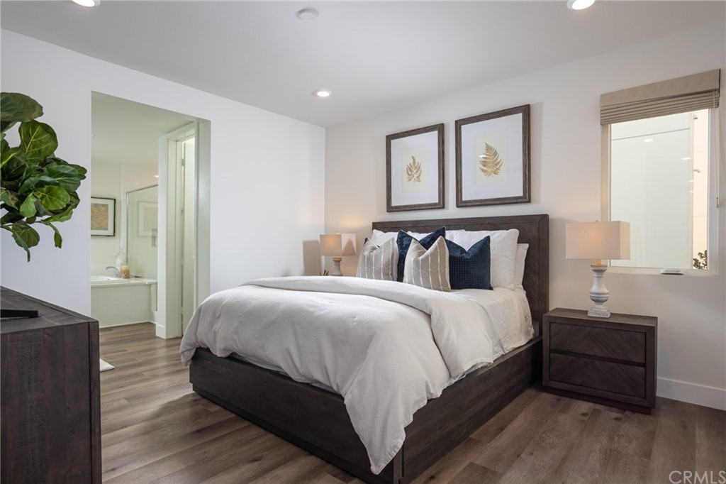 82 Ballast Point Tustin, CA 92782 - Photo 9 of 30 a bedroom with a bed and wooden floor