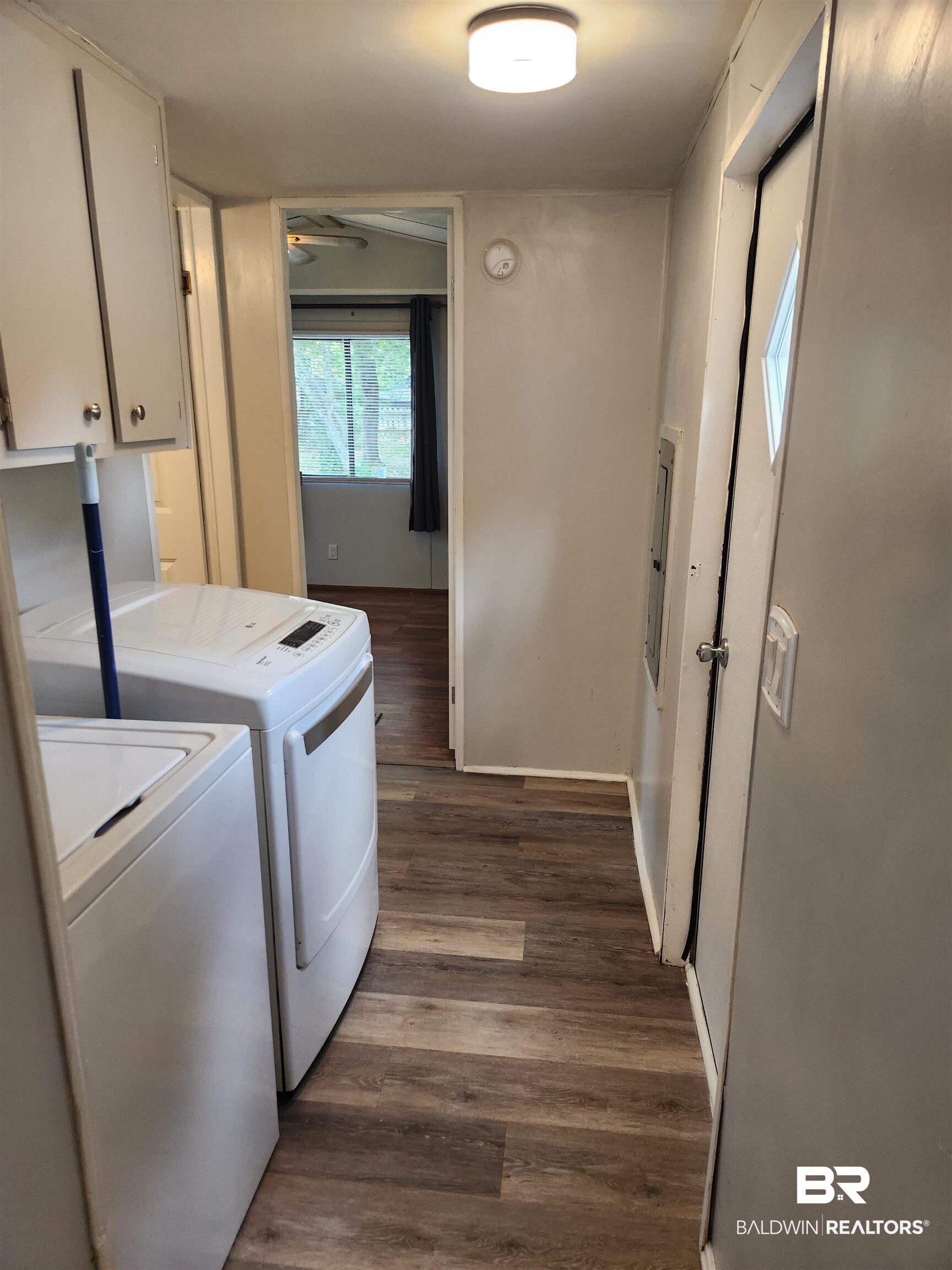 23051 Fritz Lane Foley, AL 36535 - Photo 22 of 26 Hallway featuring wood-finish flooring and a flush-mount ceiling light