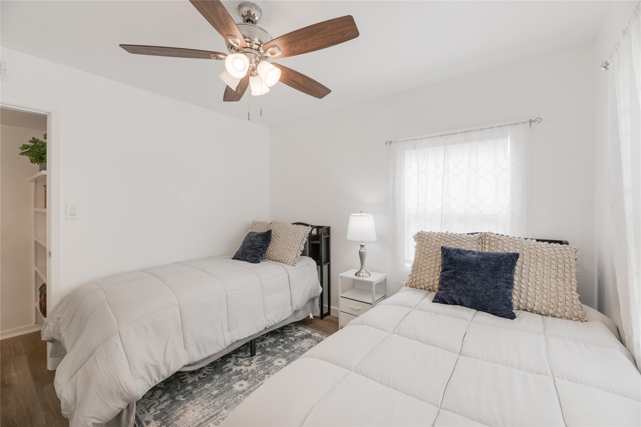 445 West Vaughan Street Bertram, TX 78605 - Photo 11 of 23 a bedroom with bed and a chandelier