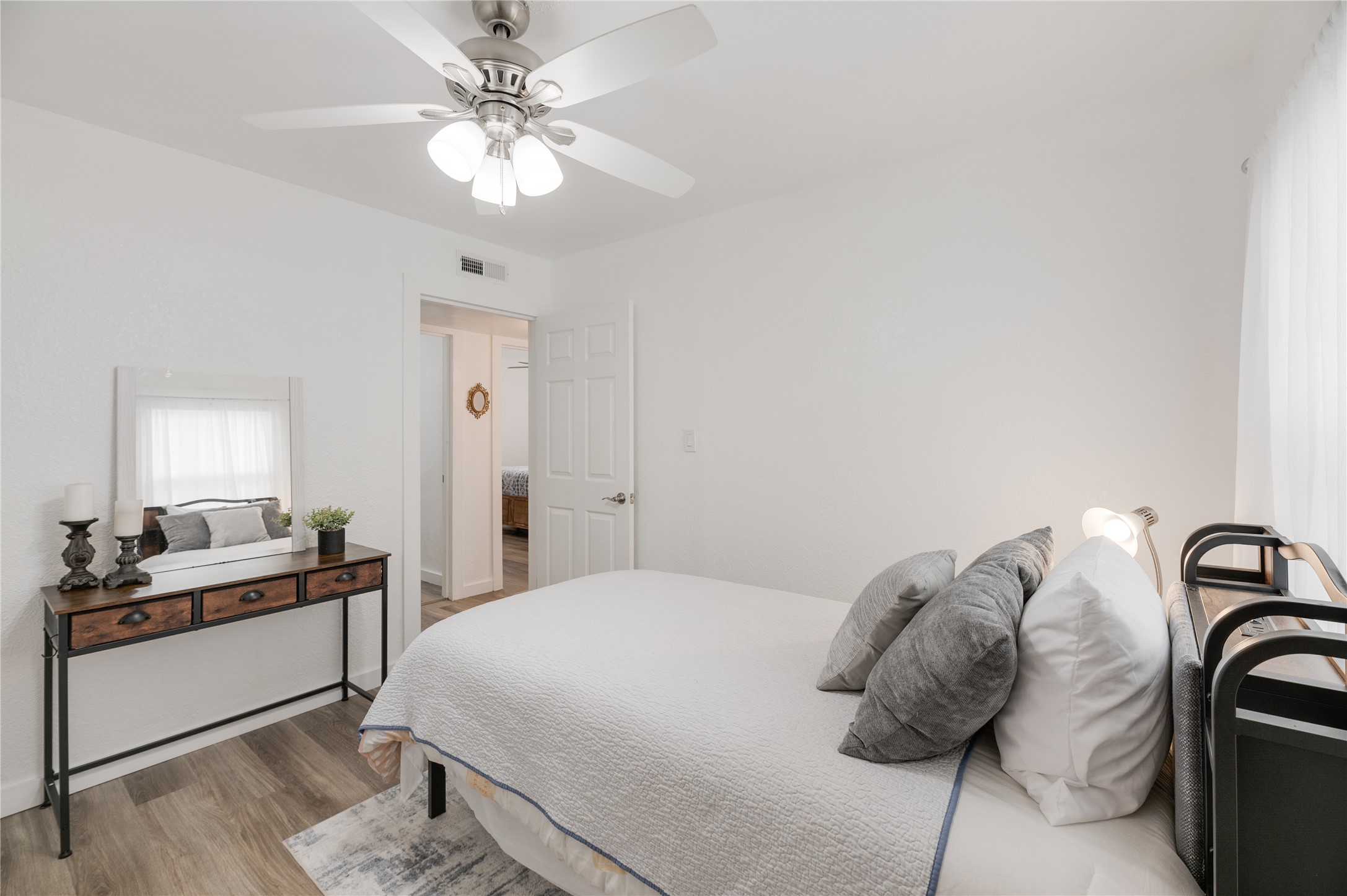 445 West Vaughan Street Bertram, TX 78605 - Photo 12 of 23 a bedroom with a bed and a chandelier