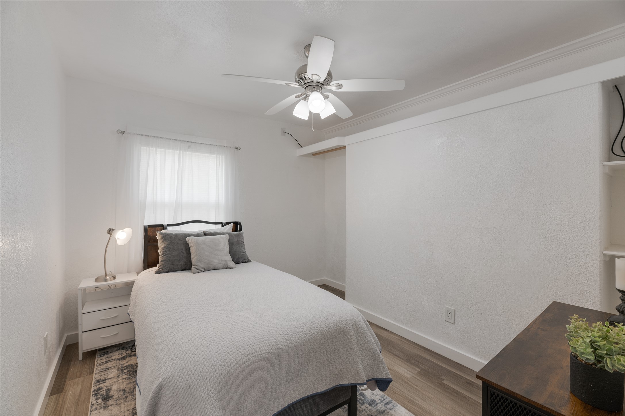 445 West Vaughan Street Bertram, TX 78605 - Photo 13 of 23 a bedroom with a bed and a chandelier