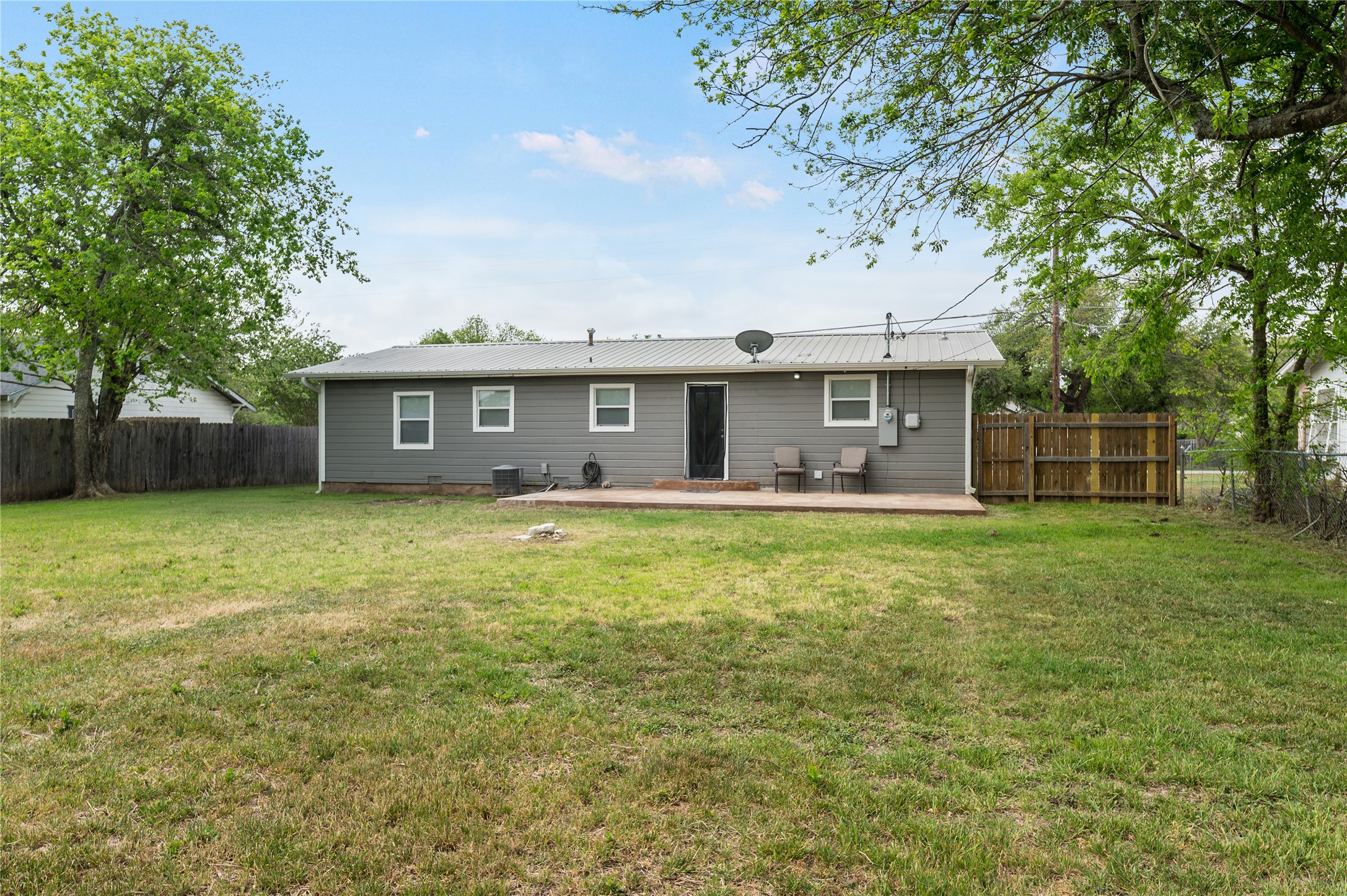 445 West Vaughan Street Bertram, TX 78605 - Photo 20 of 23 a front view of a house with a garden