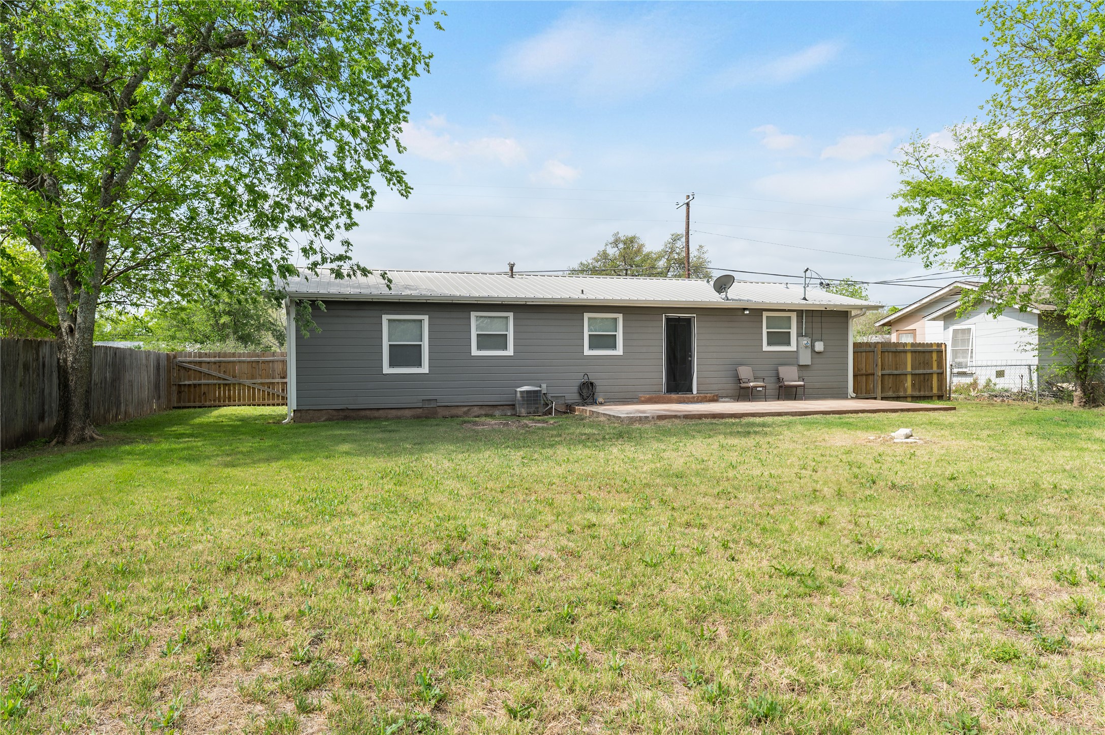 445 West Vaughan Street Bertram, TX 78605 - Photo 23 of 23 a front view of house with yard and trees in the background