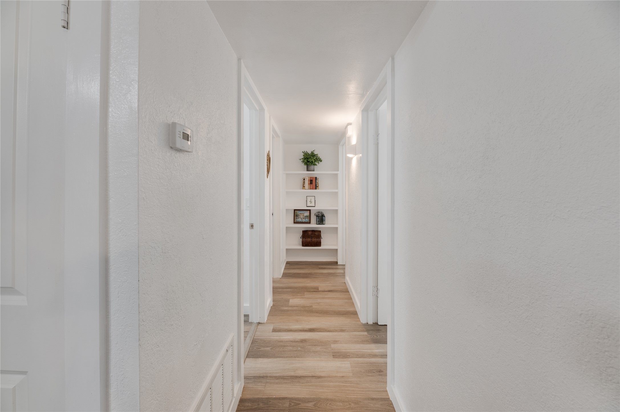 445 West Vaughan Street Bertram, TX 78605 - Photo 6 of 23 a view of a hallway with wooden floor and entryway
