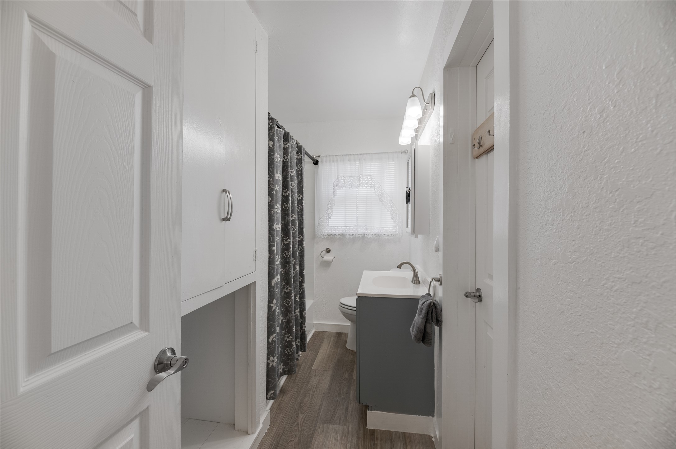445 West Vaughan Street Bertram, TX 78605 - Photo 9 of 23 a bathroom with a sink a mirror and a shower