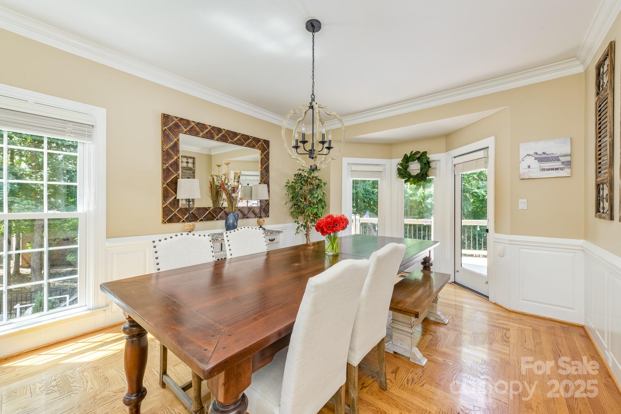 5300 Green Rea Road Charlotte, NC 28226 - Photo 16 of 42 a dining room with furniture a chandelier and wooden floor
