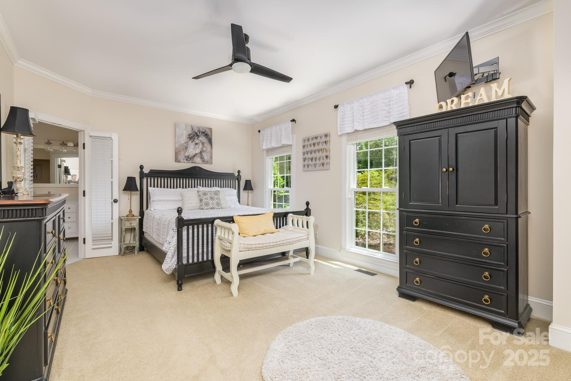 5300 Green Rea Road Charlotte, NC 28226 - Photo 22 of 42 a spacious bedroom with a bed and a chandelier