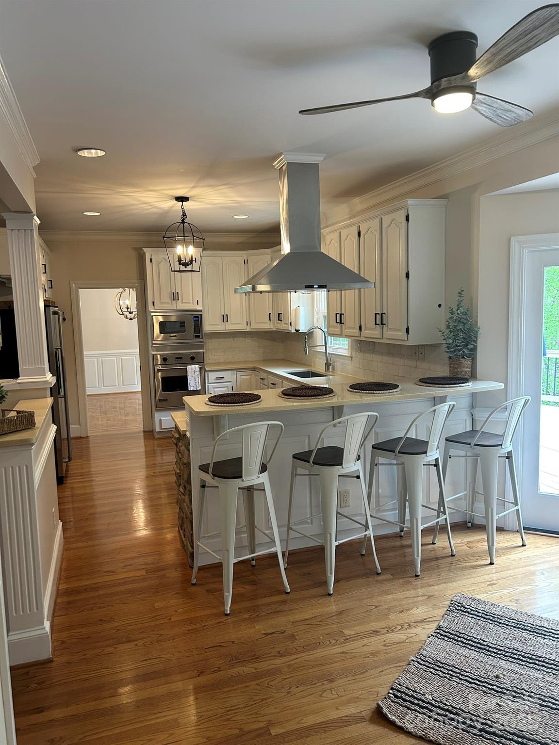 5300 Green Rea Road Charlotte, NC 28226 - Photo 9 of 42 a kitchen with stainless steel appliances kitchen island a table and chairs in it