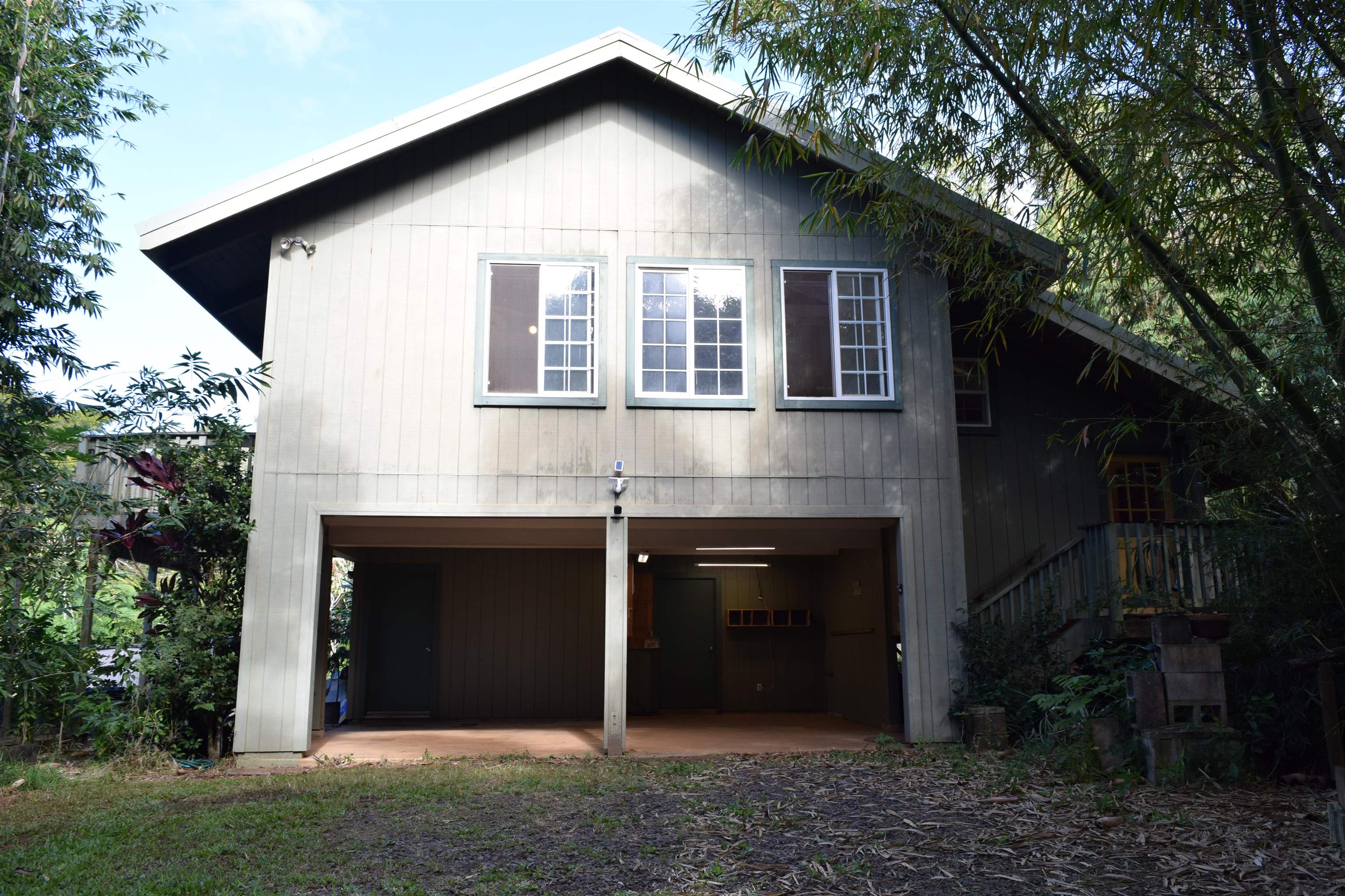 616 West Kuiaha Road Haiku, HI 96708 - Photo 4 of 30 a front view of a house with a yard and garage