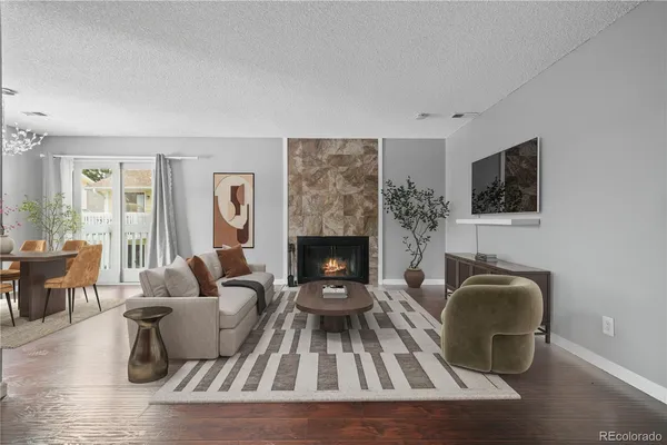 a living room with furniture and a fireplace
