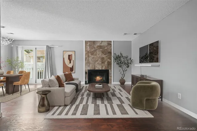 a living room with furniture and a fireplace