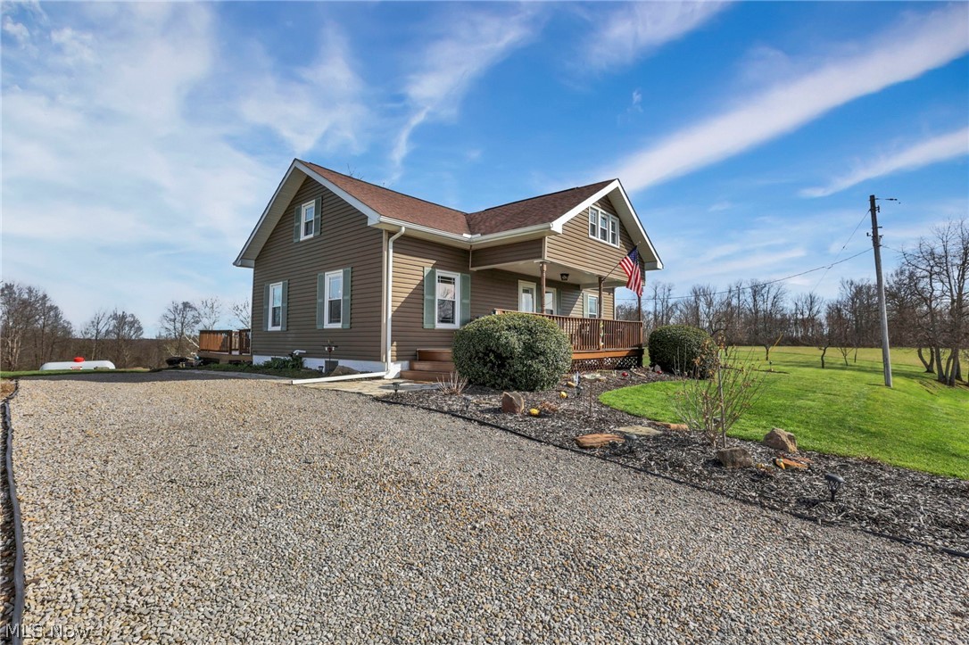 5502 Dutch Ridge Road New Straitsville, OH 43766 - Photo 5 of 49 View of side of property with a yard, driveway, a shingled roof, and a deck