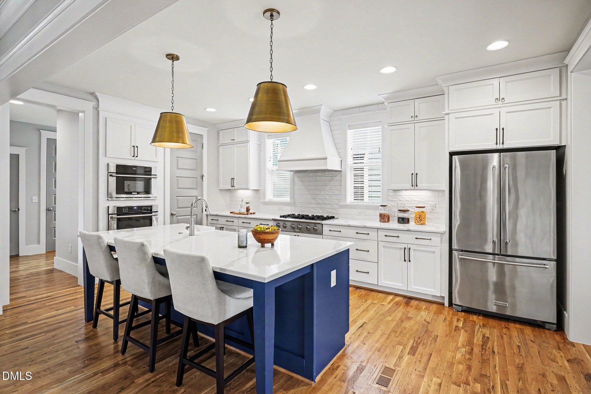824 Watercolor Way Durham, NC 27713 - Photo 8 of 28 a kitchen with stainless steel appliances granite countertop a refrigerator a sink a stove a dining table and chairs