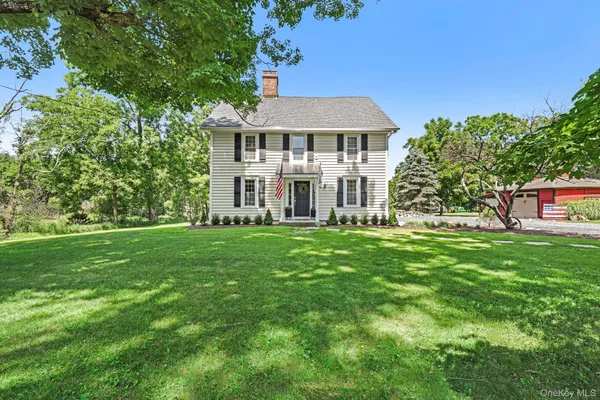 a front view of a house with a yard table and chairs