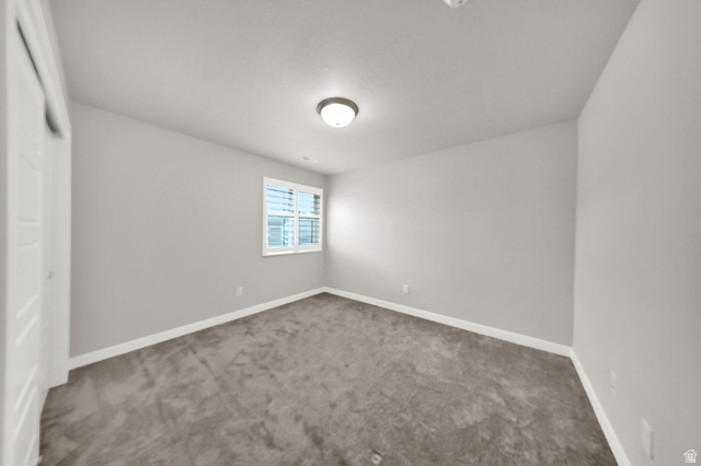 7817 West Kings Top Road Magna, UT 84044 - Photo 22 of 29 Neutral paint palette with carpeted flooring, white trim, and a window with blinds