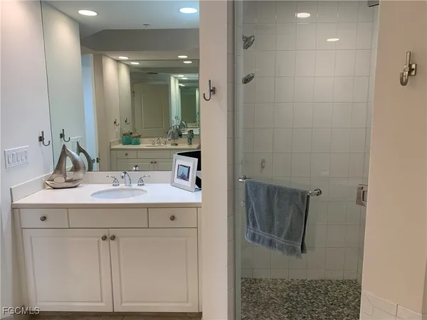 a bathroom with a sink vanity and mirror